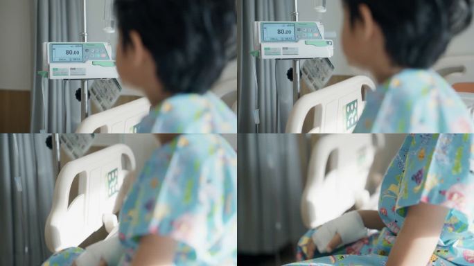 躺在医院病床上的亚洲小病人感到孤独地望着医院