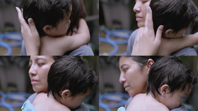 特写亚洲母亲看起来很伤心，哭着拥抱儿子。