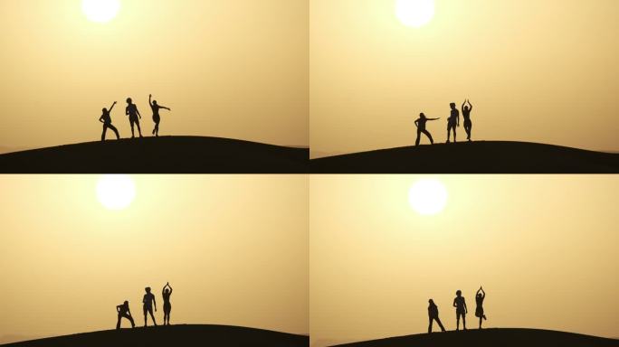 日落时分，朋友们在沙漠的沙丘上玩耍