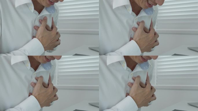 手握胸脯有心脏病发作的症状，亚洲人工作辛苦有胸痛引起的心脏病，漏、扩张、冠状动脉增大，压在胸口上有疼