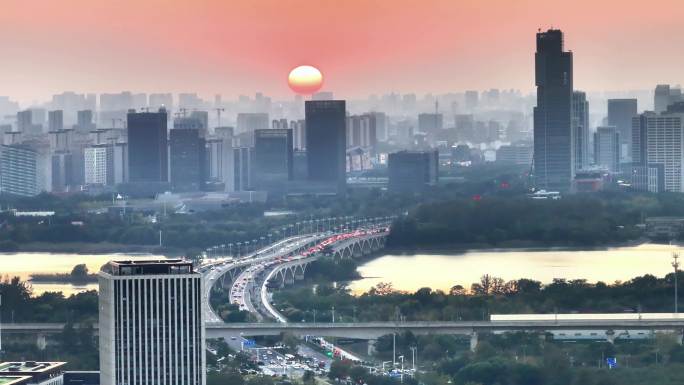 航拍夕阳高铁行驶桥梁河流车流建筑群高楼