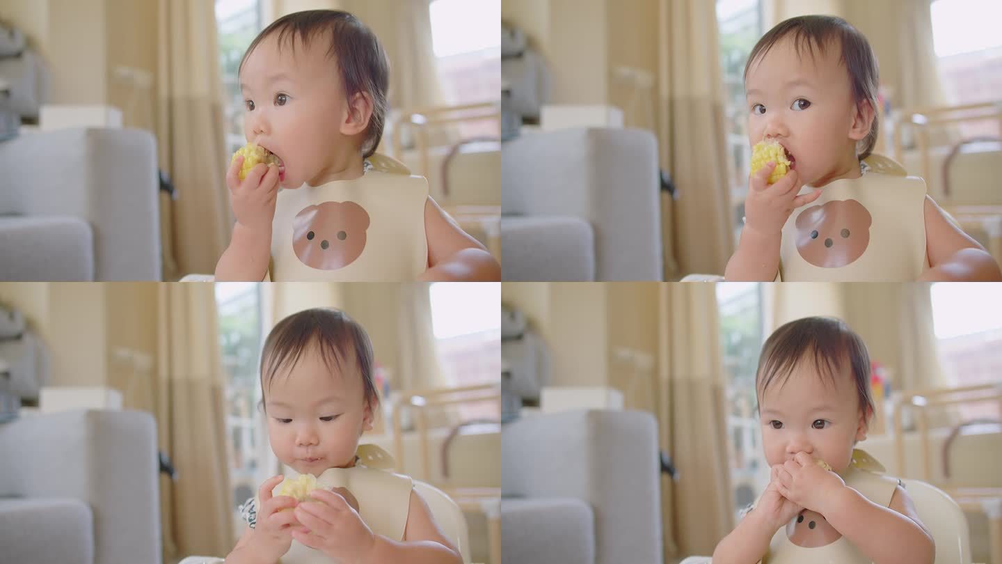 快乐可爱可爱的亚洲小女孩喜欢吃新鲜的蔬菜玉米，在家里开心和微笑，快乐的BLW健康营养餐时间