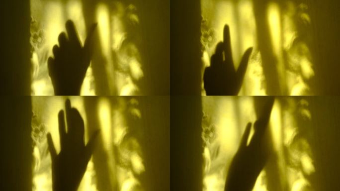 模糊的阴影女性手在黄色墙壁背景与线条花卉图案。抽象，漏光。大气的心情