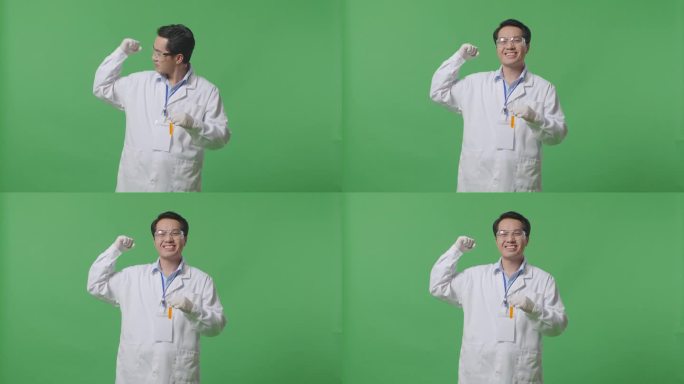 试管里有橙色液体的亚洲男性科学家站在实验室的绿色背景屏幕上微笑着弯曲他的二头肌