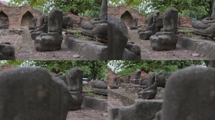 在泰国清迈乌蒙寺，破碎的佛像与美丽的古代佛像在绿色的自然中间，收集了长满苔藓的老佛头和半身像