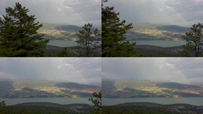 加拿大山脉的美景，俯瞰不列颠哥伦比亚省内陆地区莱克country的伍德湖。彩虹延伸到云中。