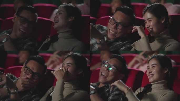 亚洲夫妇喜欢在电影院看搞笑的电影喜剧。快乐的年轻亚洲夫妇在周末坐在电影院的座位上看电影和笑
