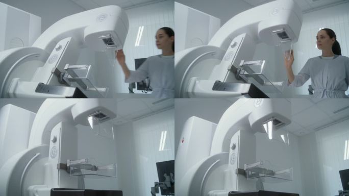女医生使用电脑，然后为病人设置乳房x光机