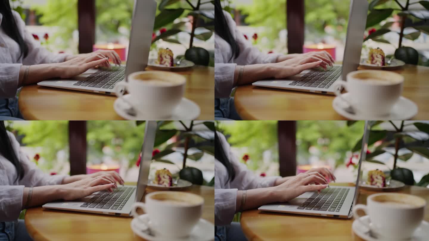 女自由职业者在咖啡馆用笔记本电脑工作，手在键盘上的特写，在线工作