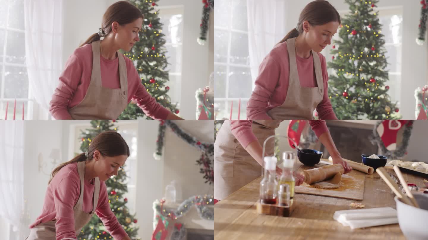 女厨师在家里为圣诞节准备面团和姜饼饼干的肖像。快乐的小企业主为她的商店精心制作自制糕点，为假期做准备