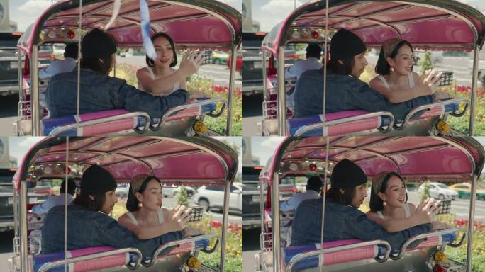 快乐的年轻夫妇在当地出租车上探索曼谷的地标。