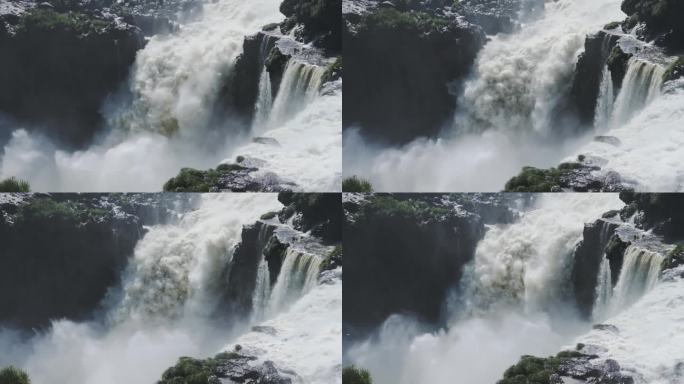 巨大的飞溅的水，巨大的瀑布撞击到下面的大跳水池，坚硬的侵蚀岩石景观从侵略性的瀑布水流在伊瓜苏瀑布，阿