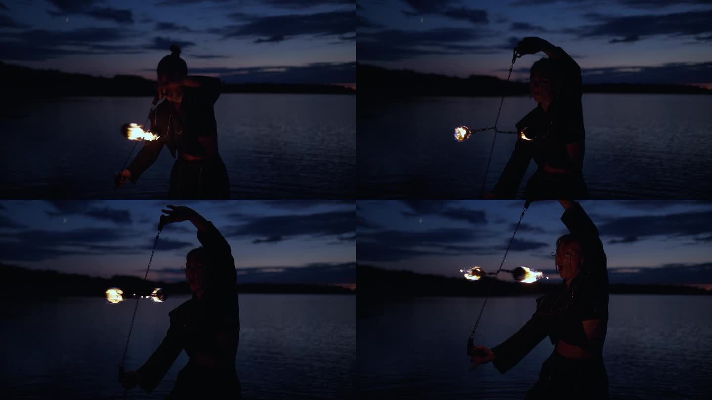 专业女特技演员夜间在河滩上用火表演危险的特技