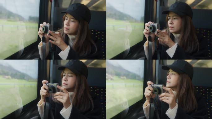 激动人心的亚洲女子乘火车到瑞士山区度假时，用相机从窗户拍下了视频