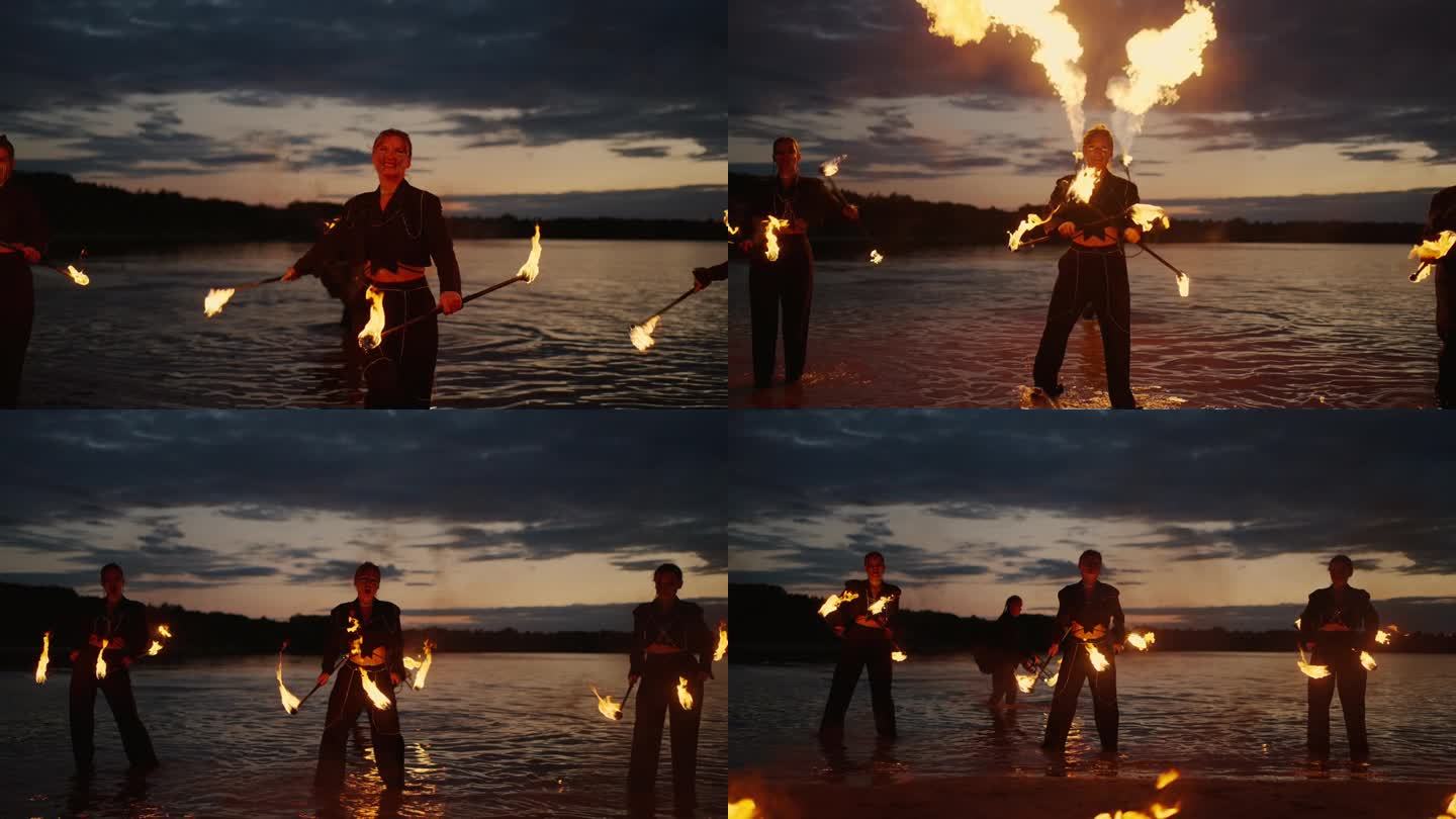 美丽的女人与火共舞，日落后的湖岸专业火表演
