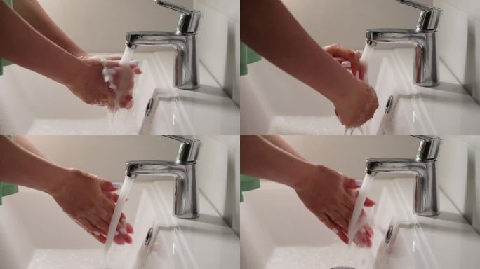 年轻的女性洗手时用自来水搓澡