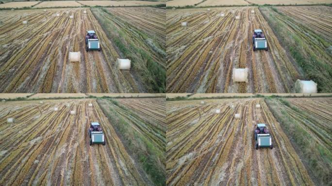 拖拉机与打包机收割，使圆形秸秆包在农业领域，无人机的航拍视图