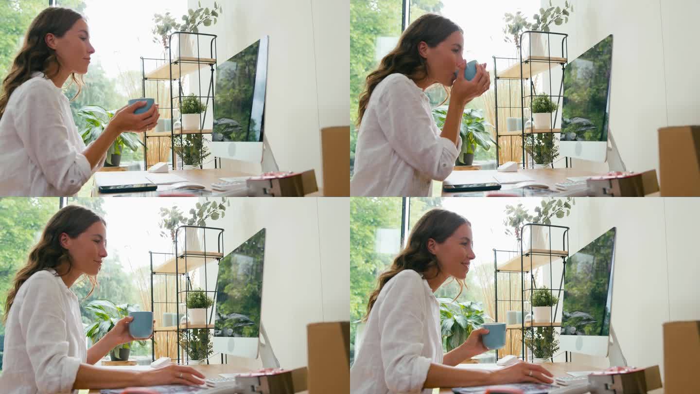 利用咖啡休息时间在家做网上生意的女人在电脑前工作