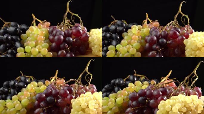 不同品种的新鲜葡萄作为背景旋转。葡萄特写，概念酿酒，葡萄酒生产，葡萄品种
