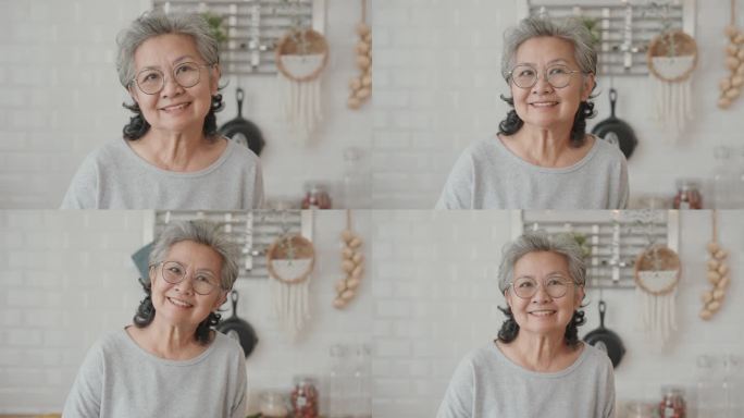一位微笑的老妇人在厨房做饭的画像。