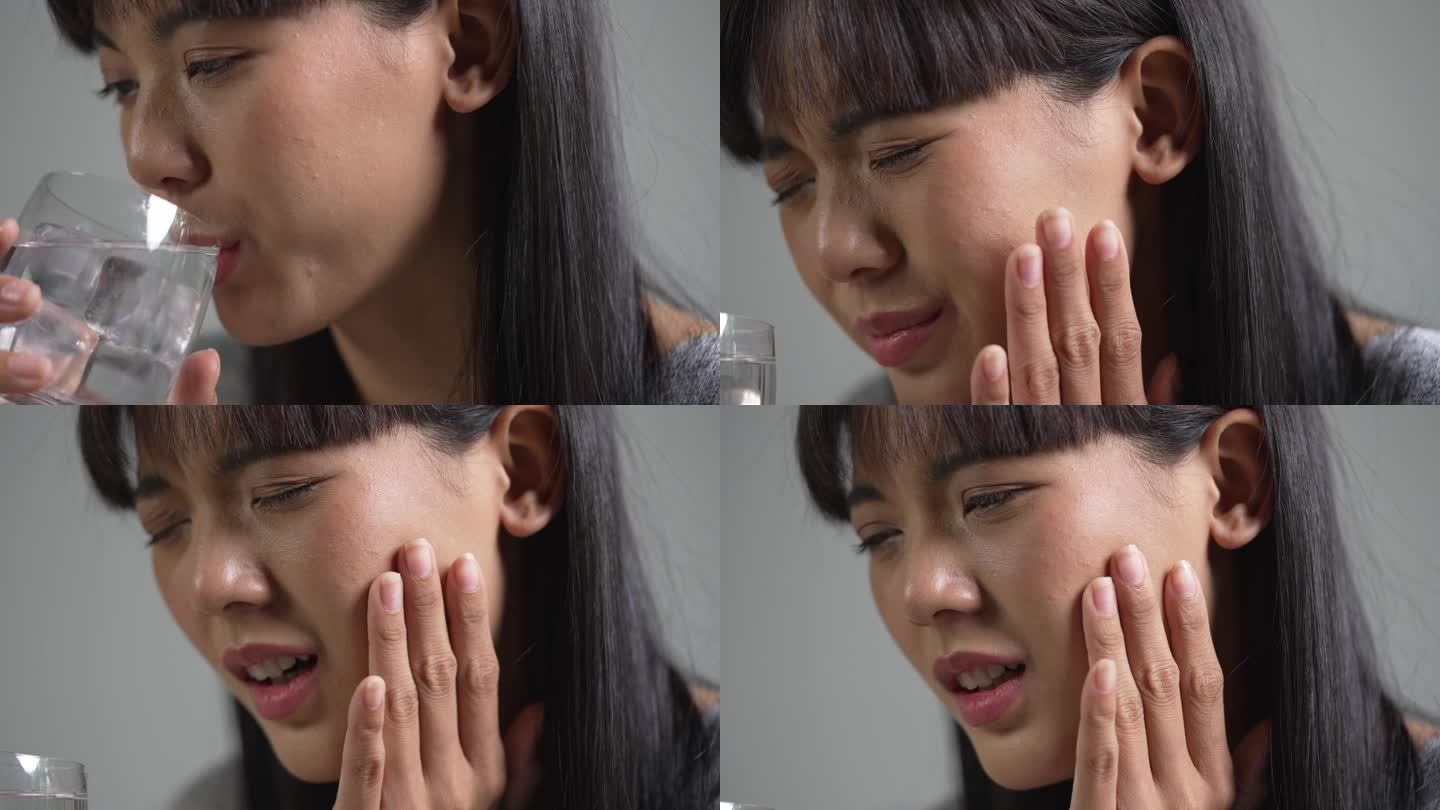 年轻的亚洲女子在喝装有冰块的水时牙痛。医疗保健理念。