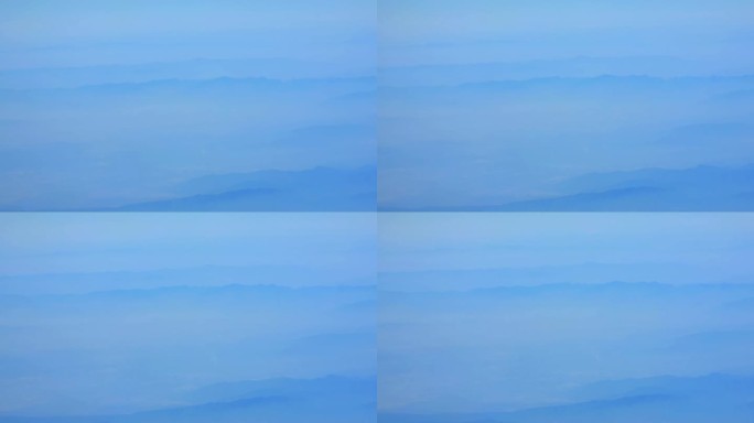 飞机窗外重峦叠嶂的山景