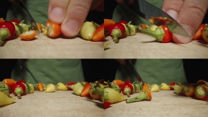 我从迷你辣椒上剪下绿色的小枝。多莉滑块极端特写。