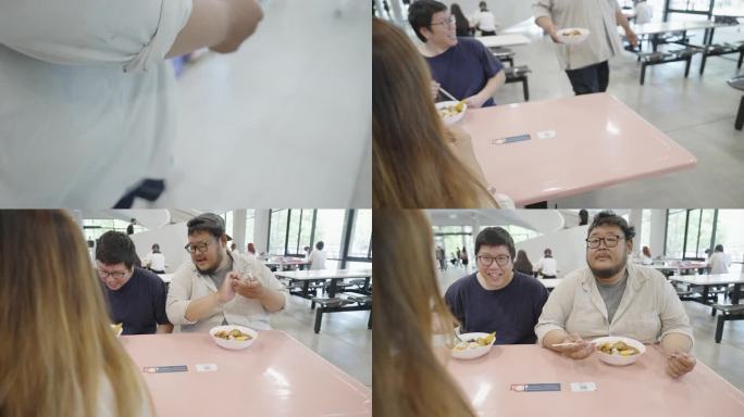一群亚洲朋友在大学食堂愉快地享用着泰国面。