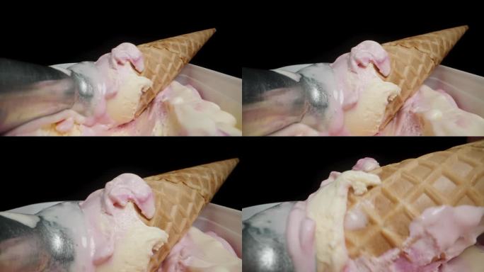 用来舀冰淇淋球的金属冰淇淋勺和华夫蛋筒一起放在容器里。当摄像机靠近时，我拿起了华夫蛋筒。