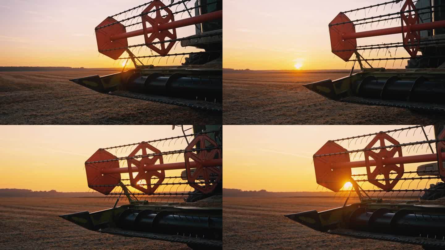 日落时农场联合收割机上巨大的转轮特写