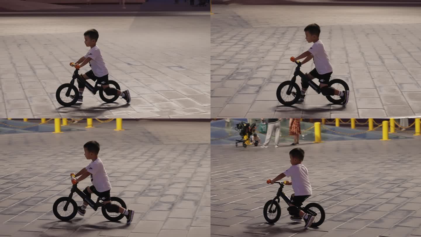 鹦鹉洲桥梁主题公园里骑平衡自行车的小男孩