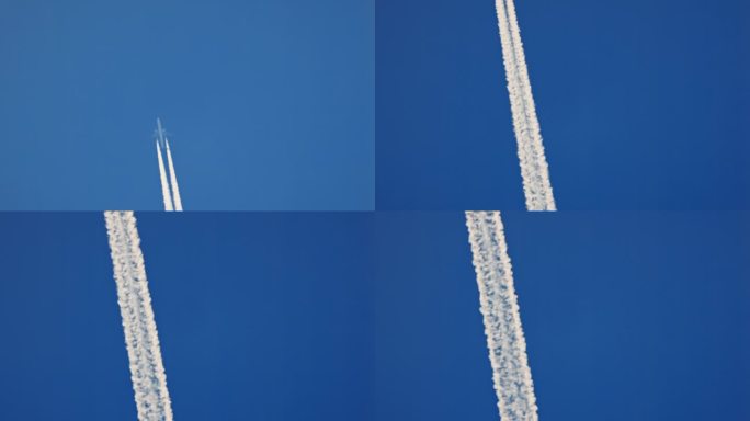 正下方的飞机在清澈的蓝天中直线移动，留下白色的蒸汽痕迹，有很多复制空间
