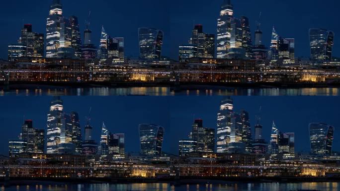 伦敦市中心的夜景，英国。市区的摩天大楼，泰晤士河上的千年桥，灯光明亮。慢动作