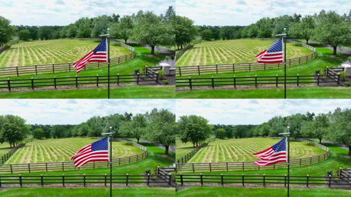美国国旗在牧场的围栏前飘扬。航拍拍摄。