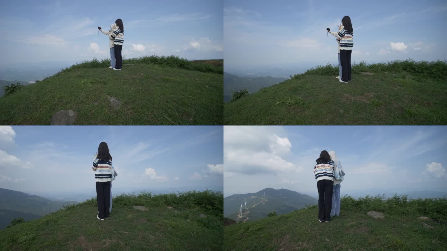 站在山顶自拍的年轻女子