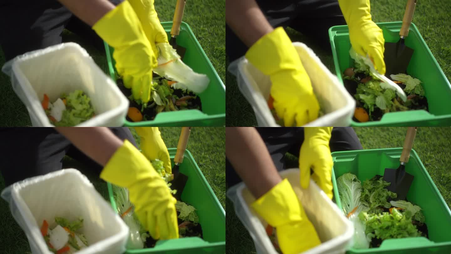 堆肥和堆肥的土壤从厨房，食物垃圾，水果，蔬菜皮和鸡蛋壳腐烂成有机肥料循环堆肥环保。减少零废物概念。