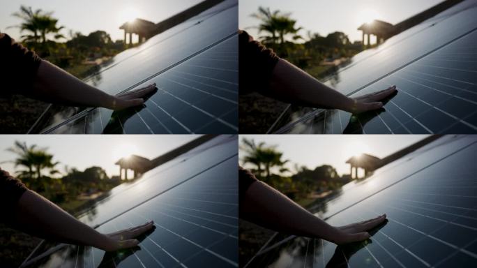 日出时，手触摸并移动太阳能电池板
