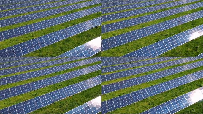 在绿色草地上排成一排的面板。太阳能转换系统。太阳反射在电池板上。清洁技术创造更美好的未来。