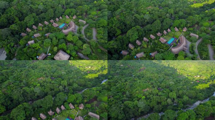 在哥伦比亚的丛林山上，有私人游泳池的茅草屋顶小屋。鸟瞰图