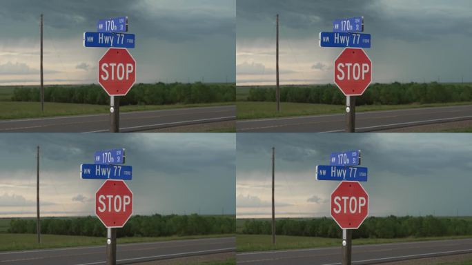 弗林特山高速公路上的停车标志，远处有雷暴和雨云