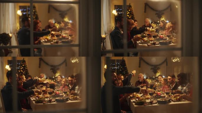 快乐的家庭团聚在家里吃传统的圣诞晚餐，烤火鸡。客厅里挤满了享用节日菜肴的老人和年轻人。透过雪窗的创意