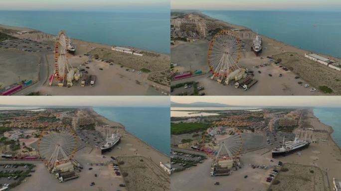 夏季Les Barcares海滩鸟瞰图。旅游旺季，海滩上有一座摩天轮和一艘巨轮作为吸引游客的景点