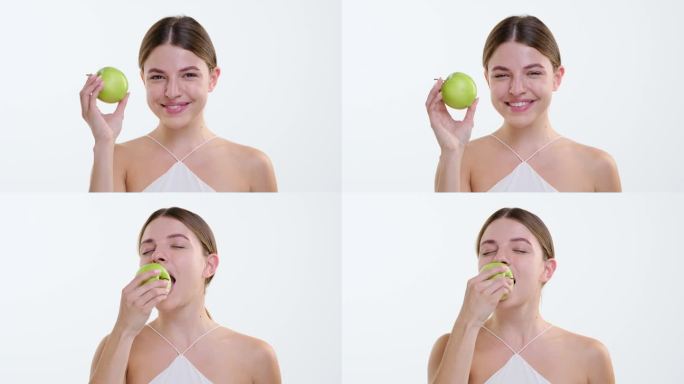 无忧无虑的女人在白底上咬青苹果