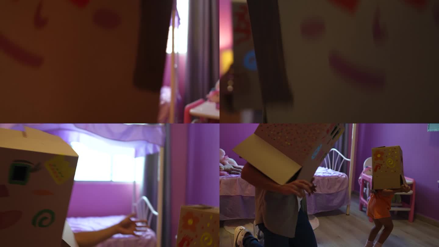 父亲和女儿在家里的卧室里顶着纸板箱玩耍