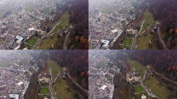 列支敦士登的瓦杜兹城堡和城市。雾蒙蒙的秋日，无人机拍摄的王室山顶宅邸