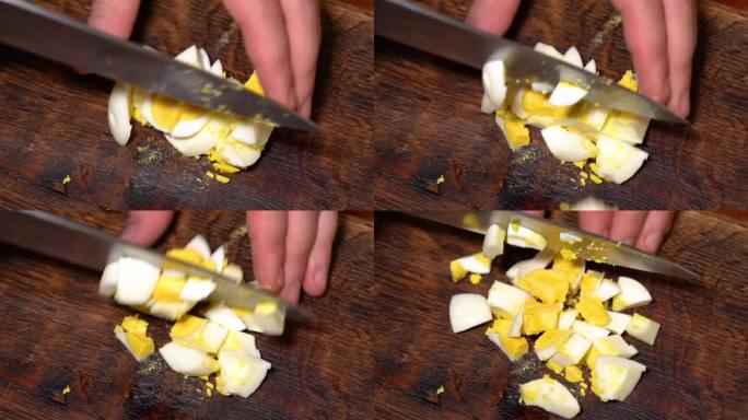 切煮熟的鸡蛋。男手拿大刀在木板上切煮熟的鸡蛋