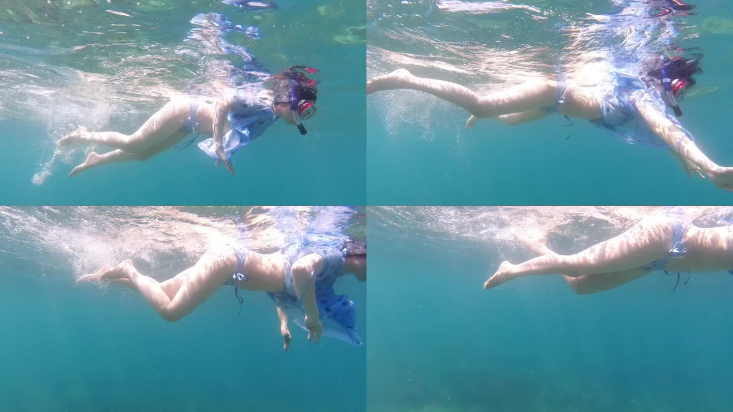 美女阳光洒在海面上浮潜游泳