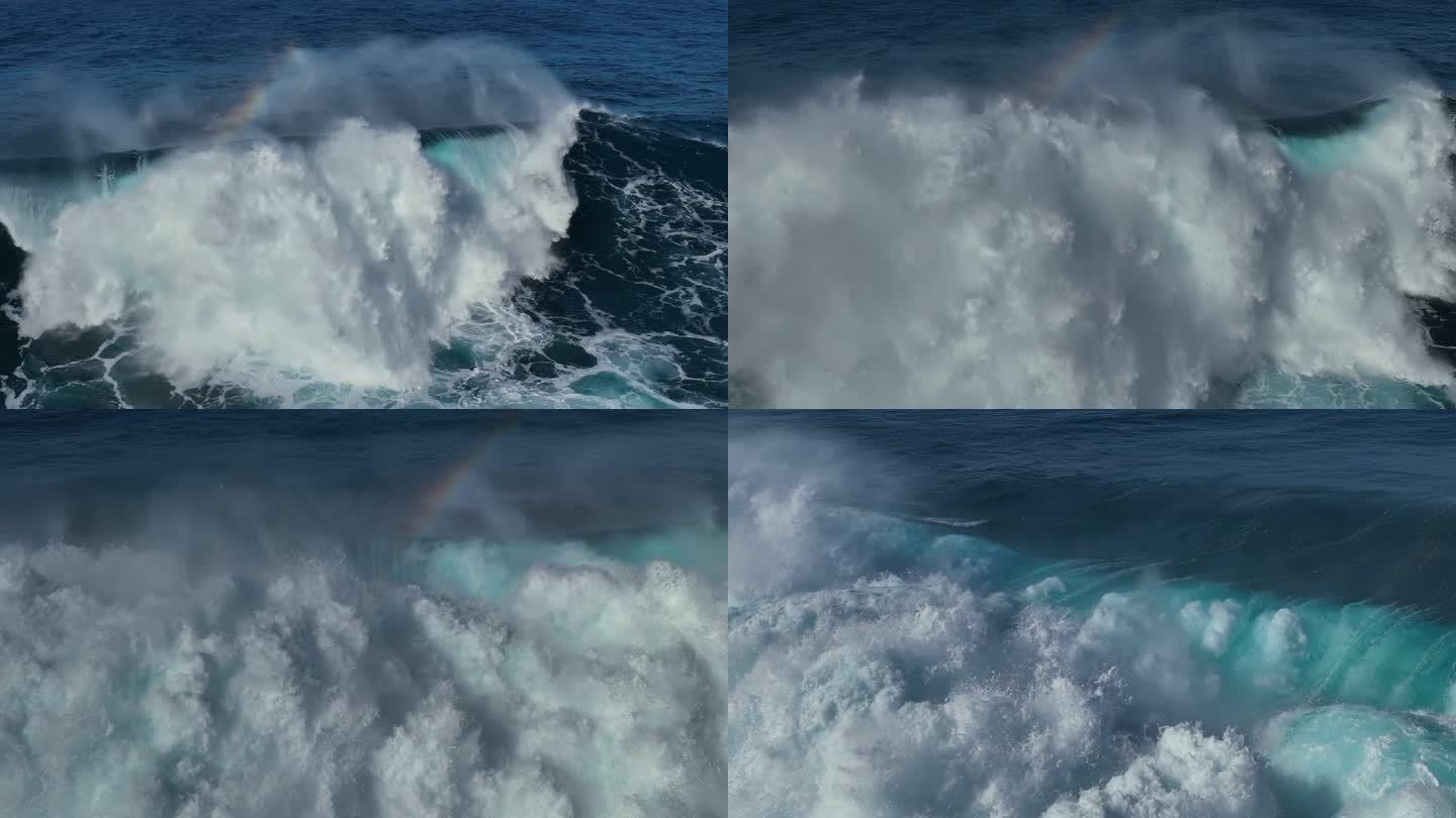 巨大的海浪带着蓝绿色的水冲出海岸，形成水花和白色的泡沫。航拍强大的海浪与小彩虹。极端史诗般的飞行非常