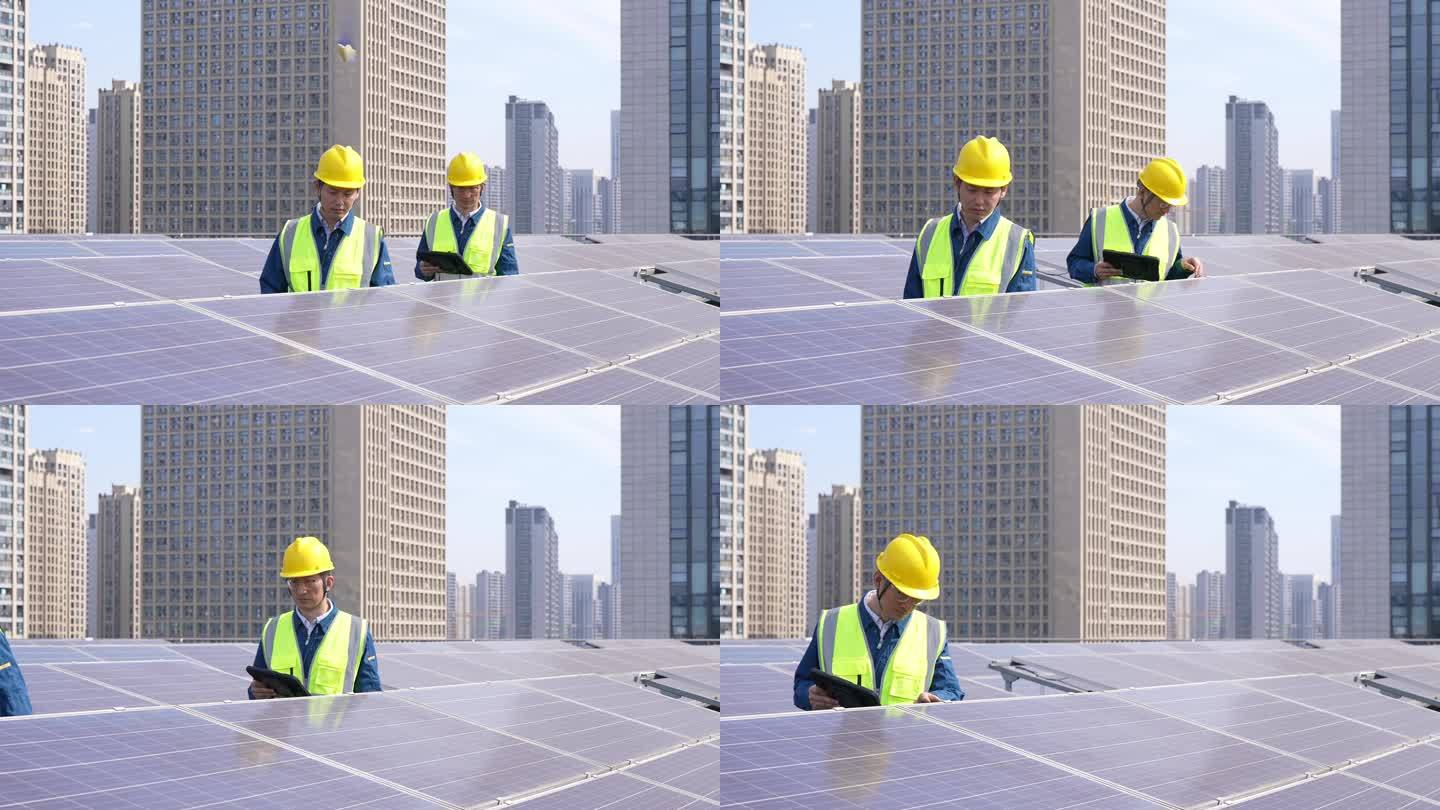 工程师在屋顶太阳能光伏发电站平板电脑工作