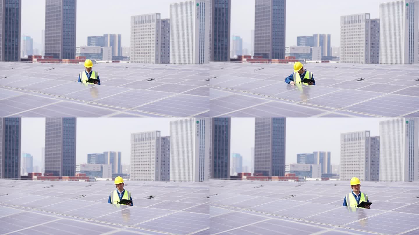 工程师在屋顶太阳能光伏发电站平板电脑工作